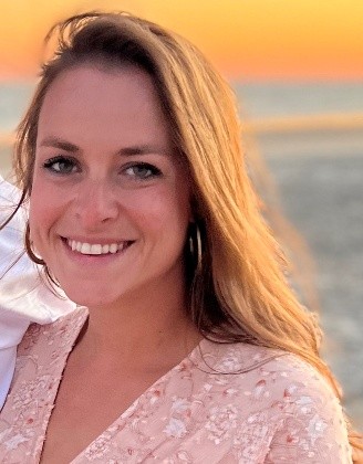 A person smiling at the cameraDescription automatically generated